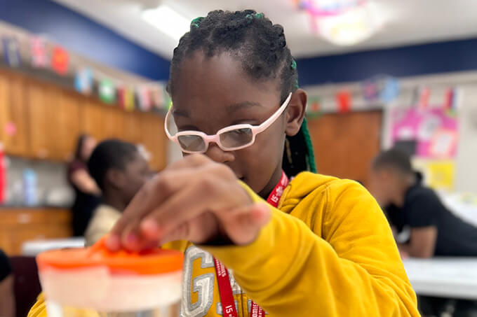 beautiful, African-American child concentrating on science experiment