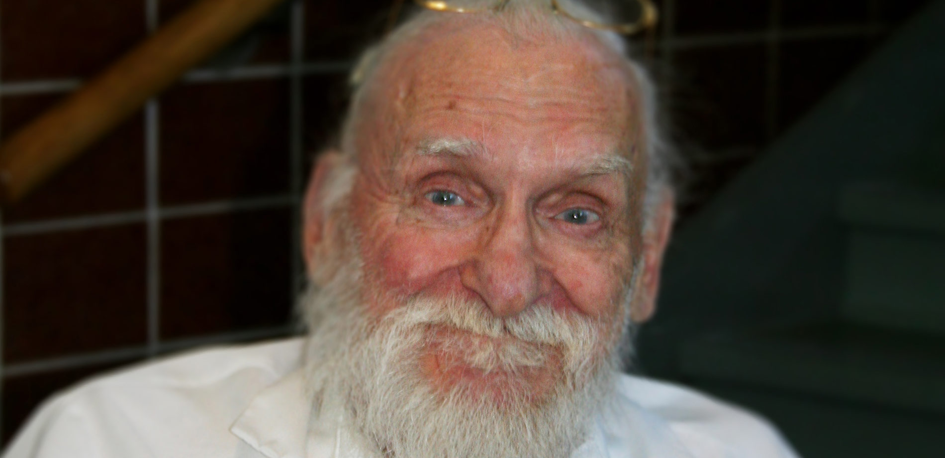 Older adult resident smiling in his housing community