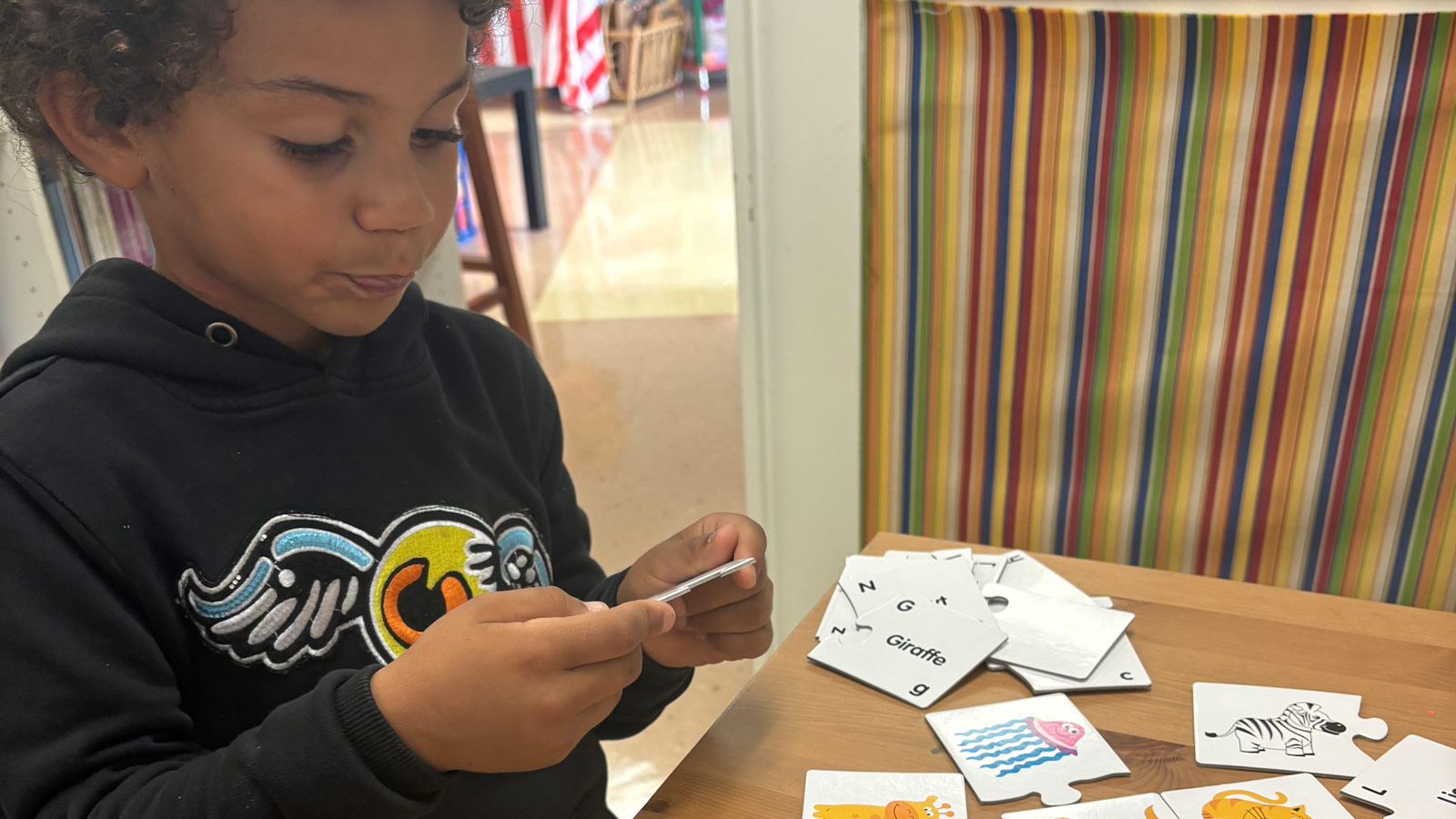 A child and mentor working together during a learning activity